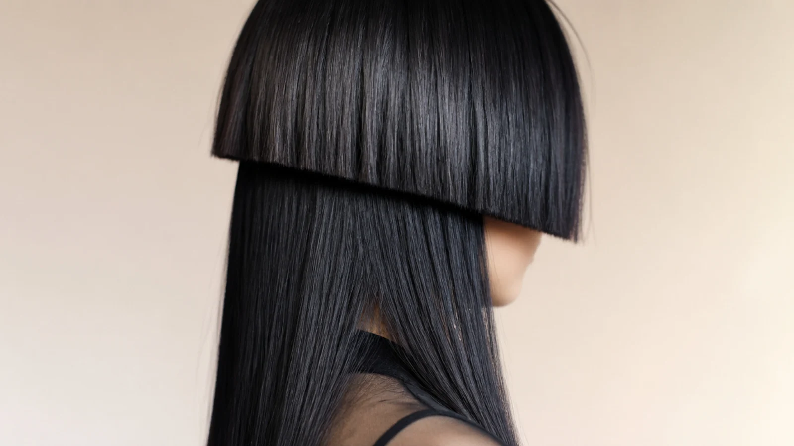 Punk aesthetic jellyfish haircut with a blunt cheekbone-length black bowl over long straight black hair