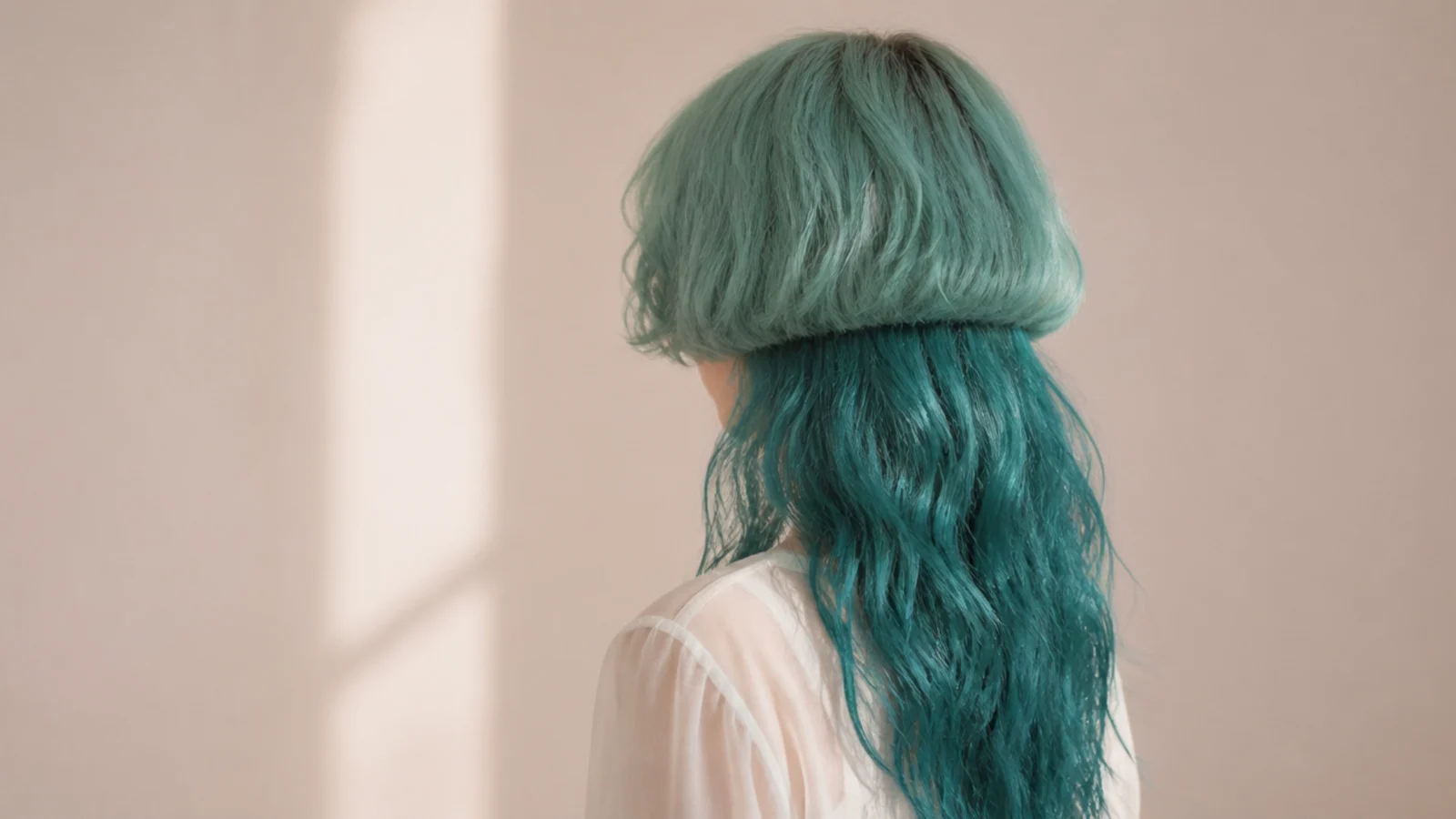 Mermaidcore jellyfish haircut on 2b waves with a teal-tinted bell and long sea-toned lengths