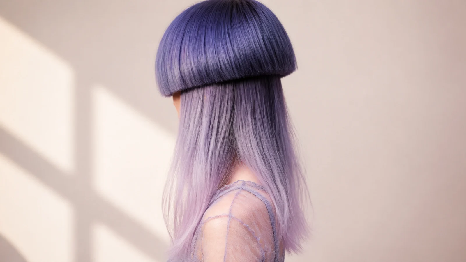 Jellyfish haircut with deep blue roots fading to lavender ends through the long tentacle lengths