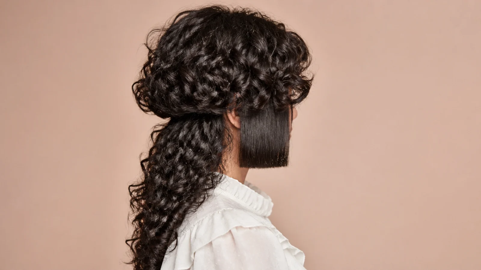 Curly jellyfish haircut with blunt hime side panels at the jaw over long disconnected curly lengths