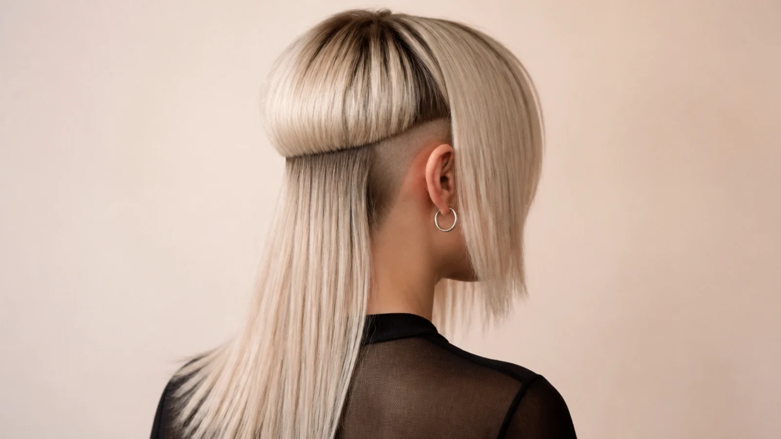 Asymmetric edgy jellyfish haircut with one shaved side panel and a bell cut longer on the opposite side