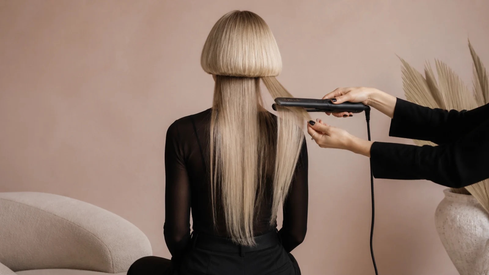 Styling an edgy jellyfish haircut with a flat iron flicking the short bell layer over long straight lengths