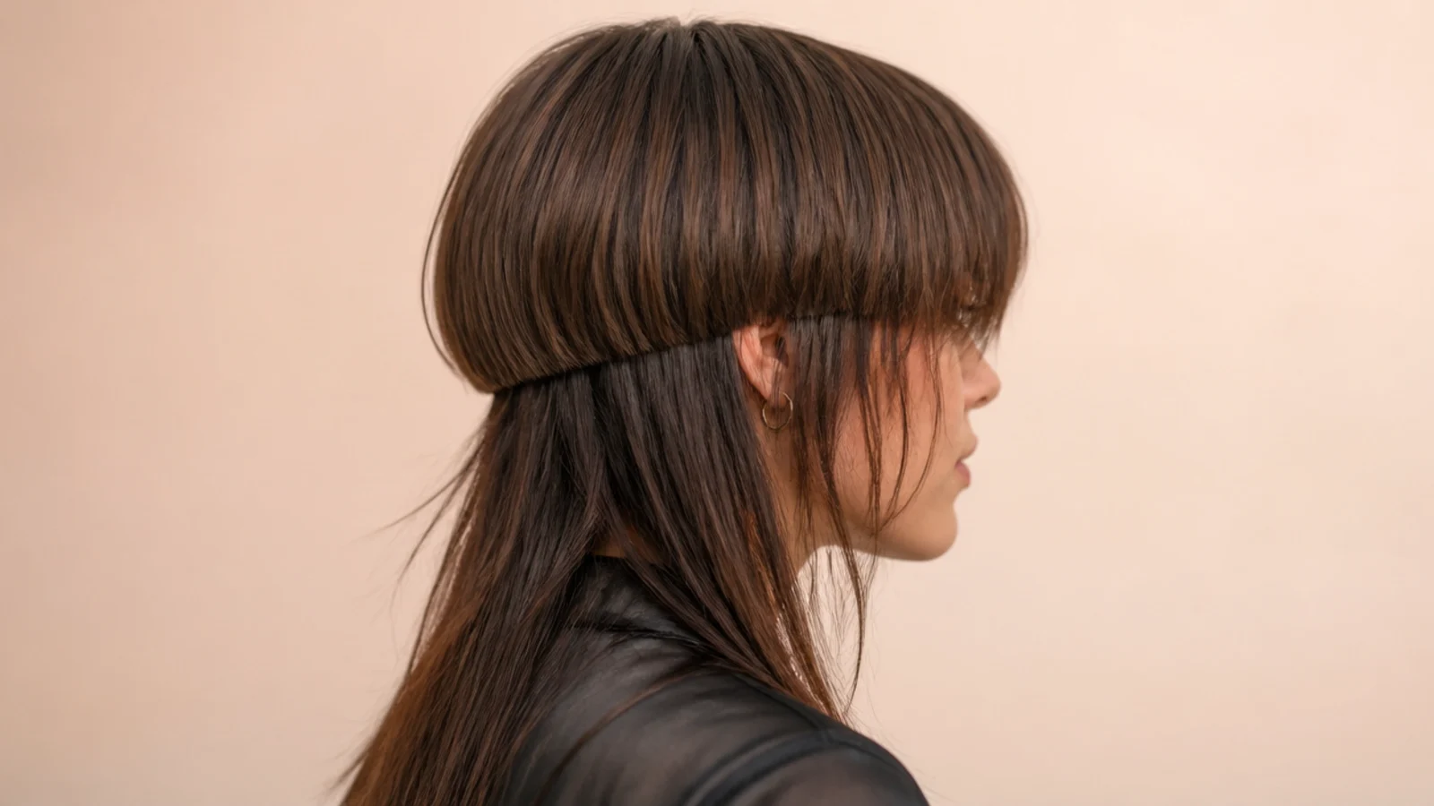 Jellyfish haircut with long wispy bangs skimming the lashes softening a square jawline