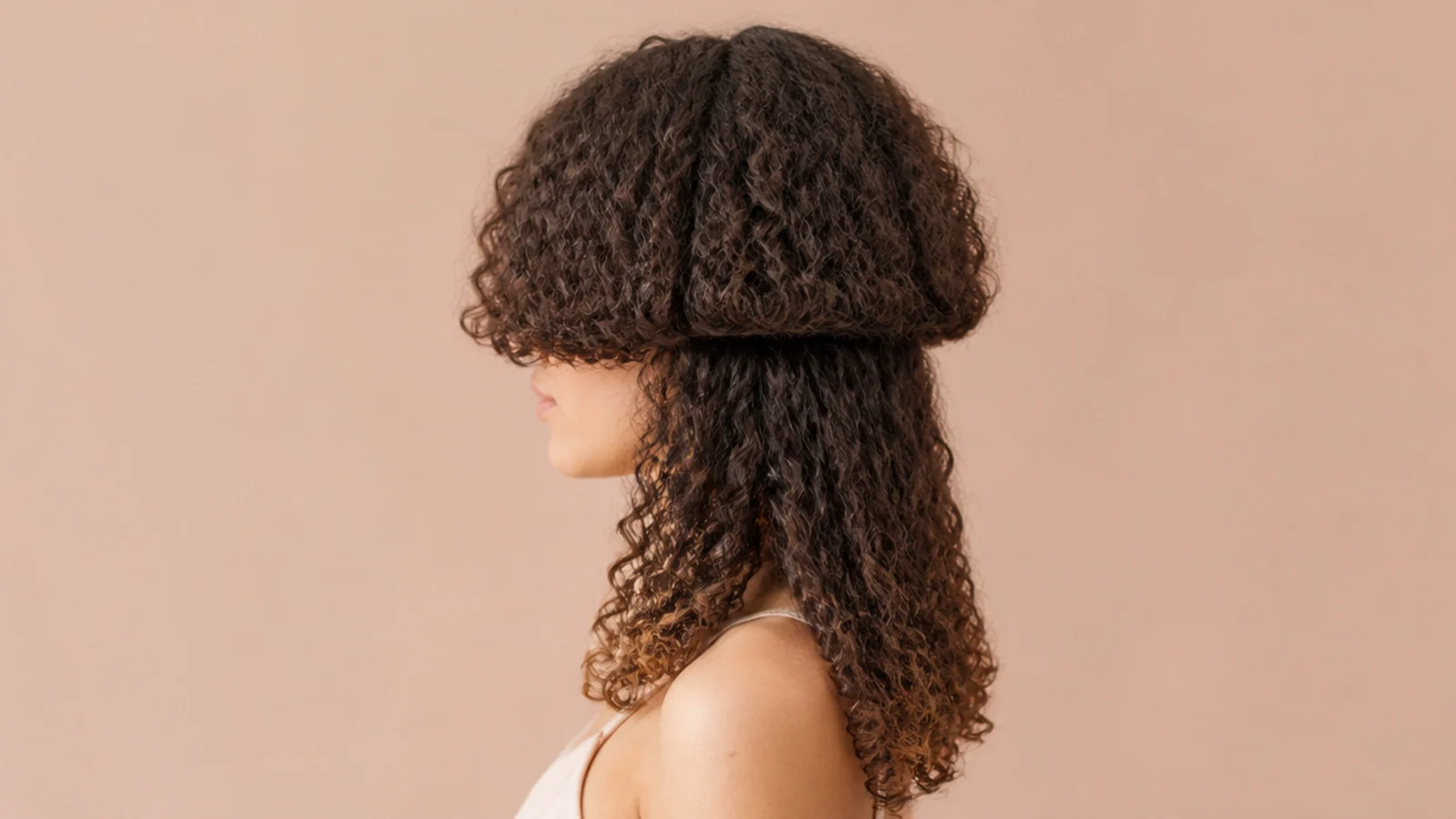 Jellyfish haircut on 3A curly hair where the bell blends into the curls instead of staying disconnected