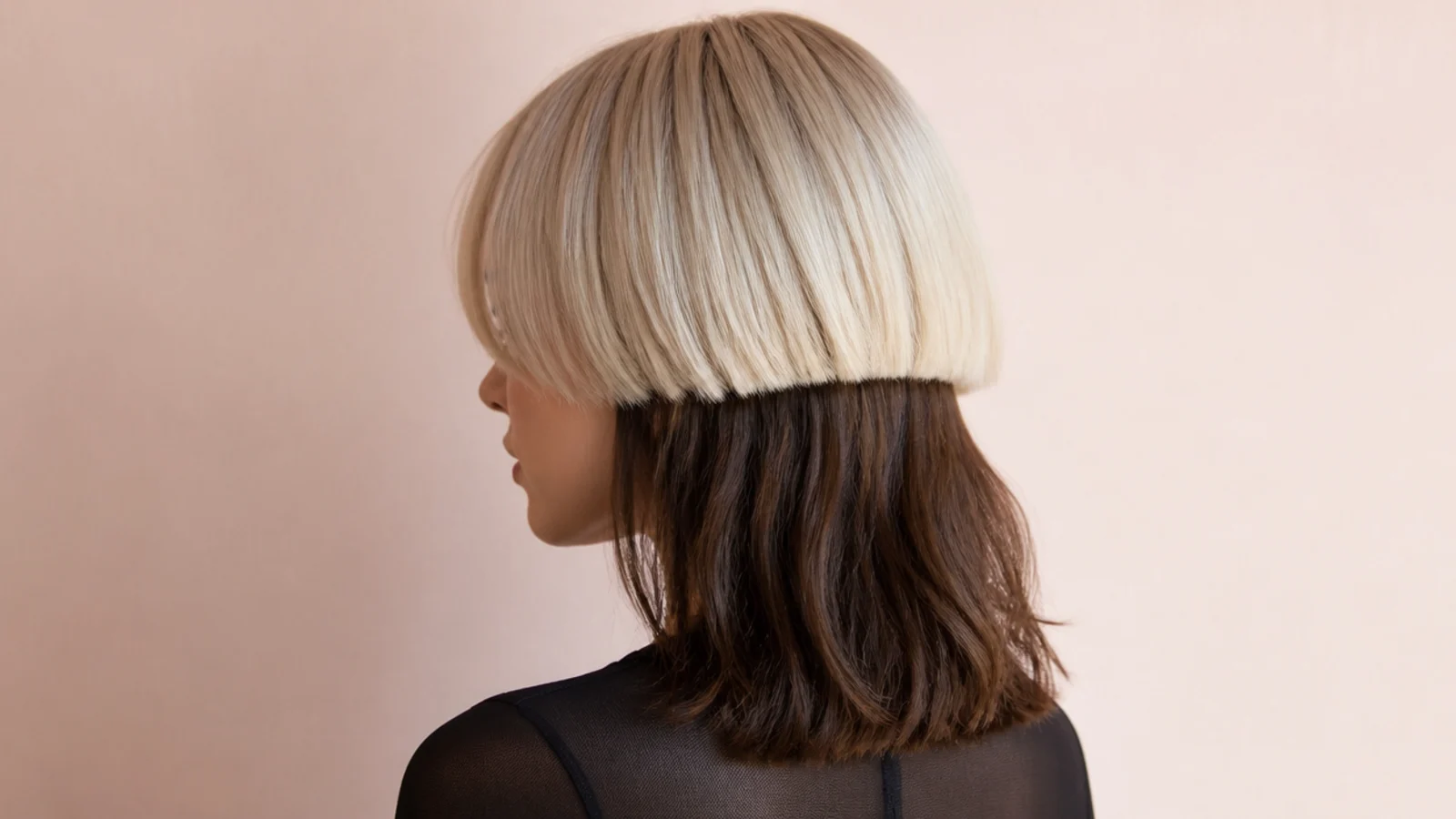 Two-tone medium jellyfish haircut with a platinum blonde bell over dark brown collarbone length hair