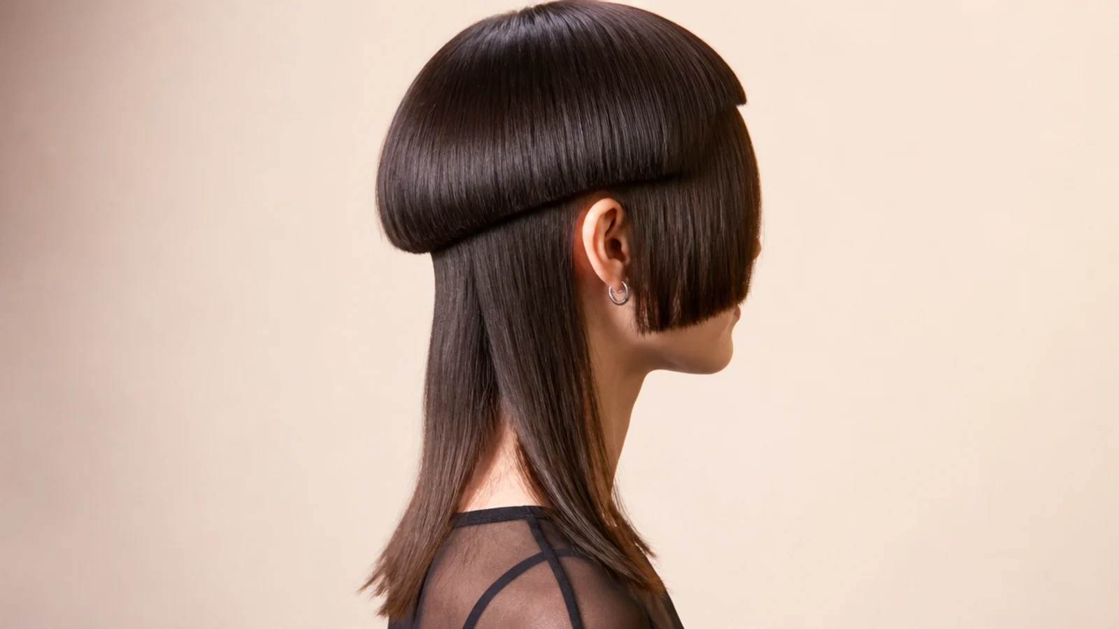 Short jellyfish haircut with blunt micro bangs high on the forehead above a rounded ear length bell