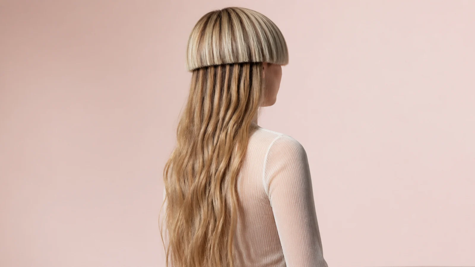 Waist length wavy tentacles falling below a short blunt bowl top in a jellyfish haircut