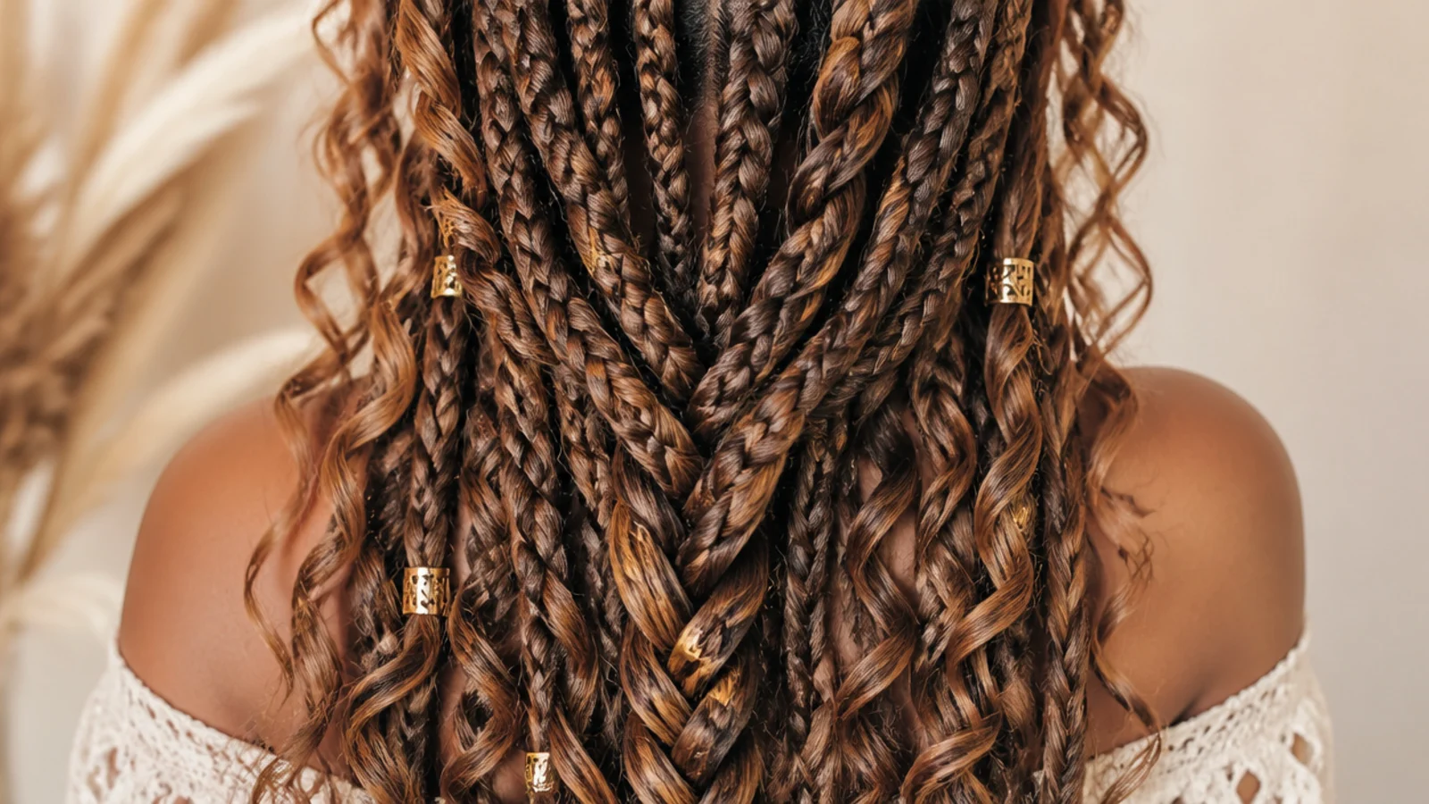 Medium size boho knotless braids sized for a six week install with curly pieces throughout