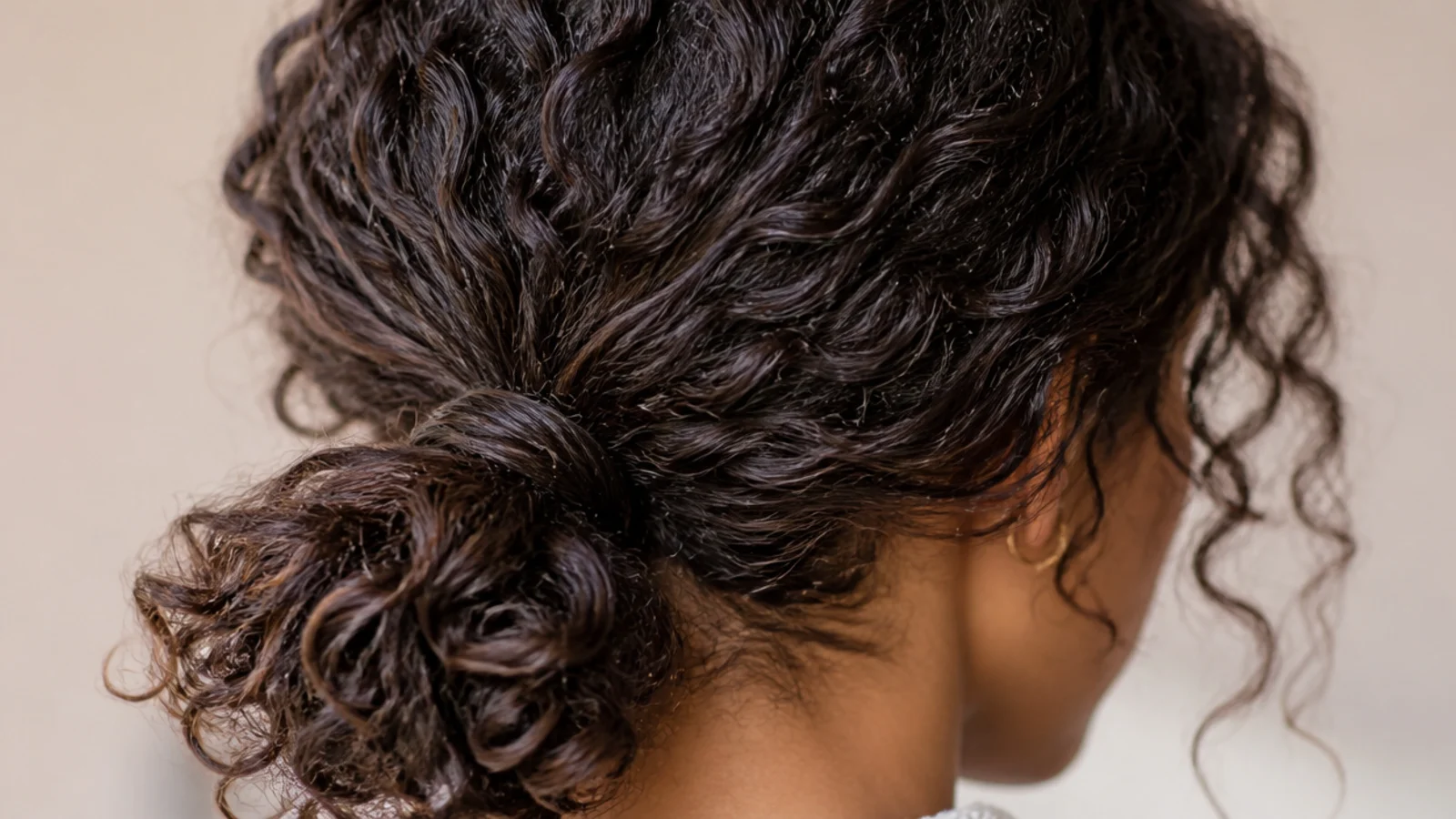 Curly low messy ponytail on 3b hair with defined coils gathered loosely at the nape
