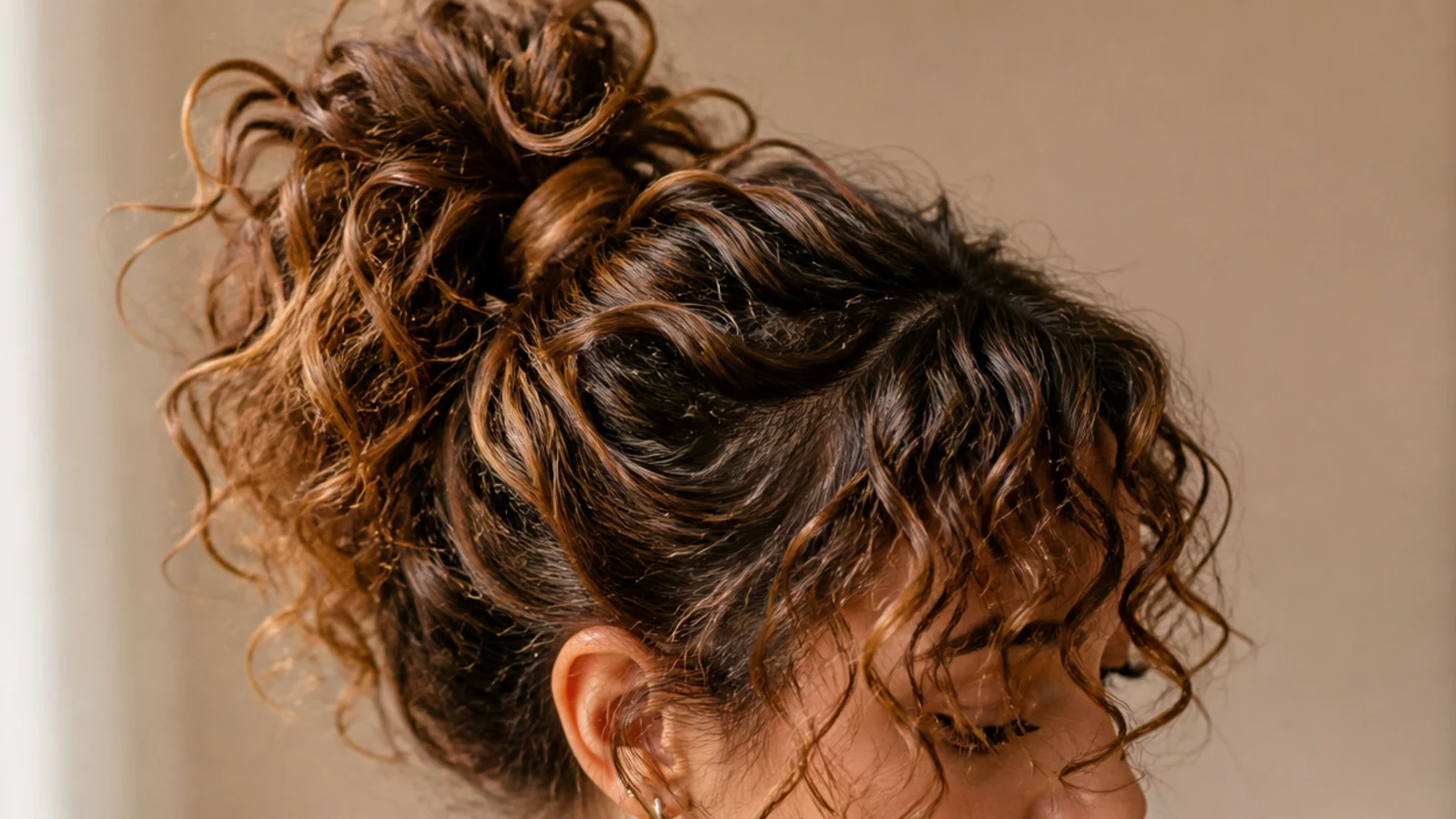 Curly curtain bangs with a high pineapple messy ponytail of 3a spiral curls