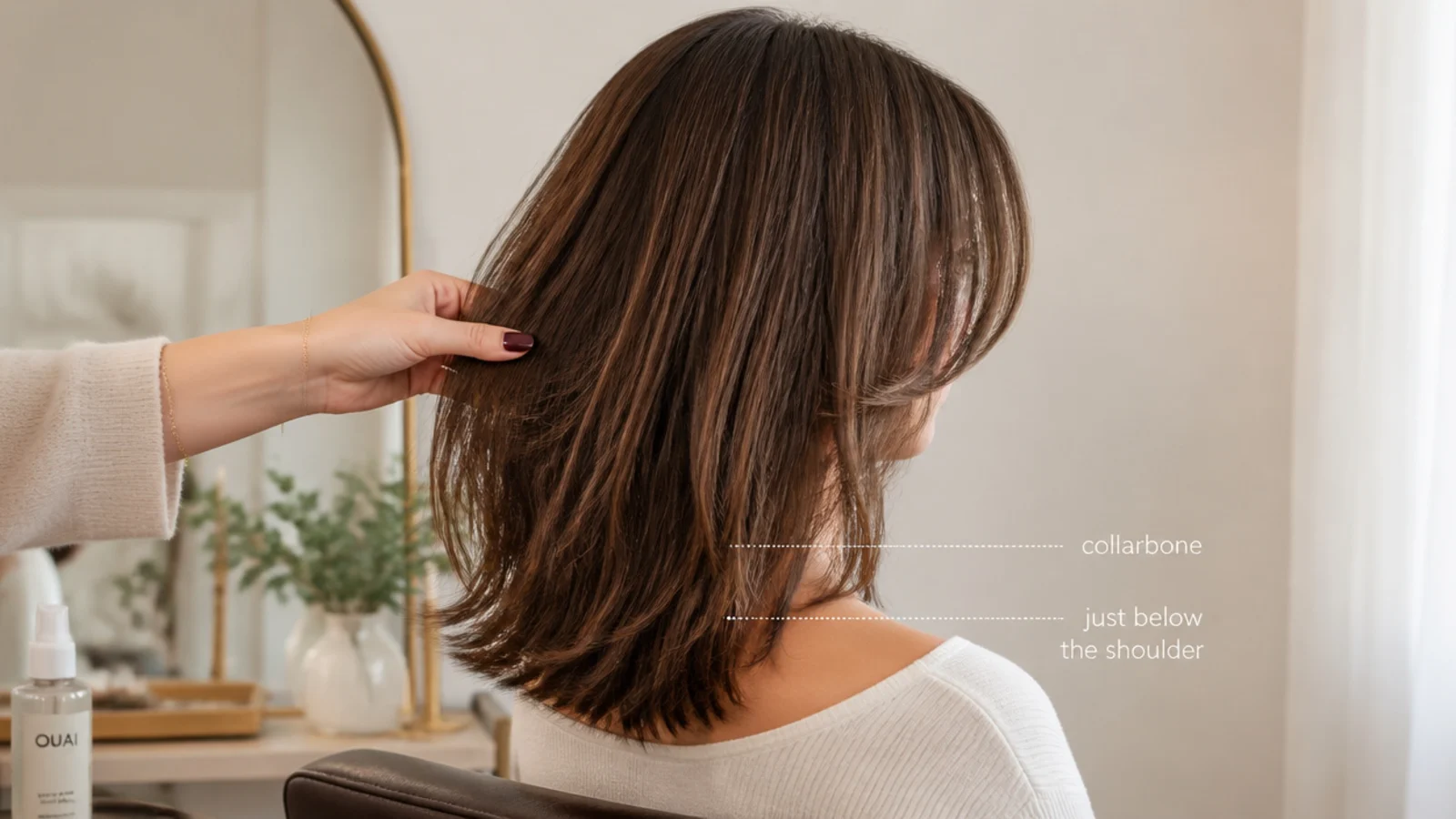 Mid length hair measured from collarbone to just below the shoulder with curtain bangs