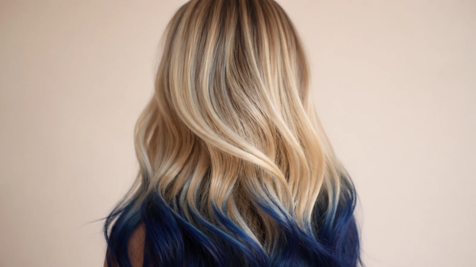 Long blonde hair with navy blue dipped ends starting below the shoulder blades, viewed from behind