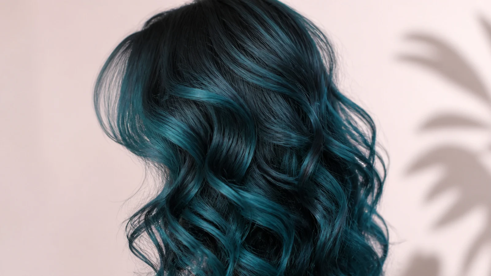 Mermaid blue color on defined natural curls with a curtain fringe, photographed from behind