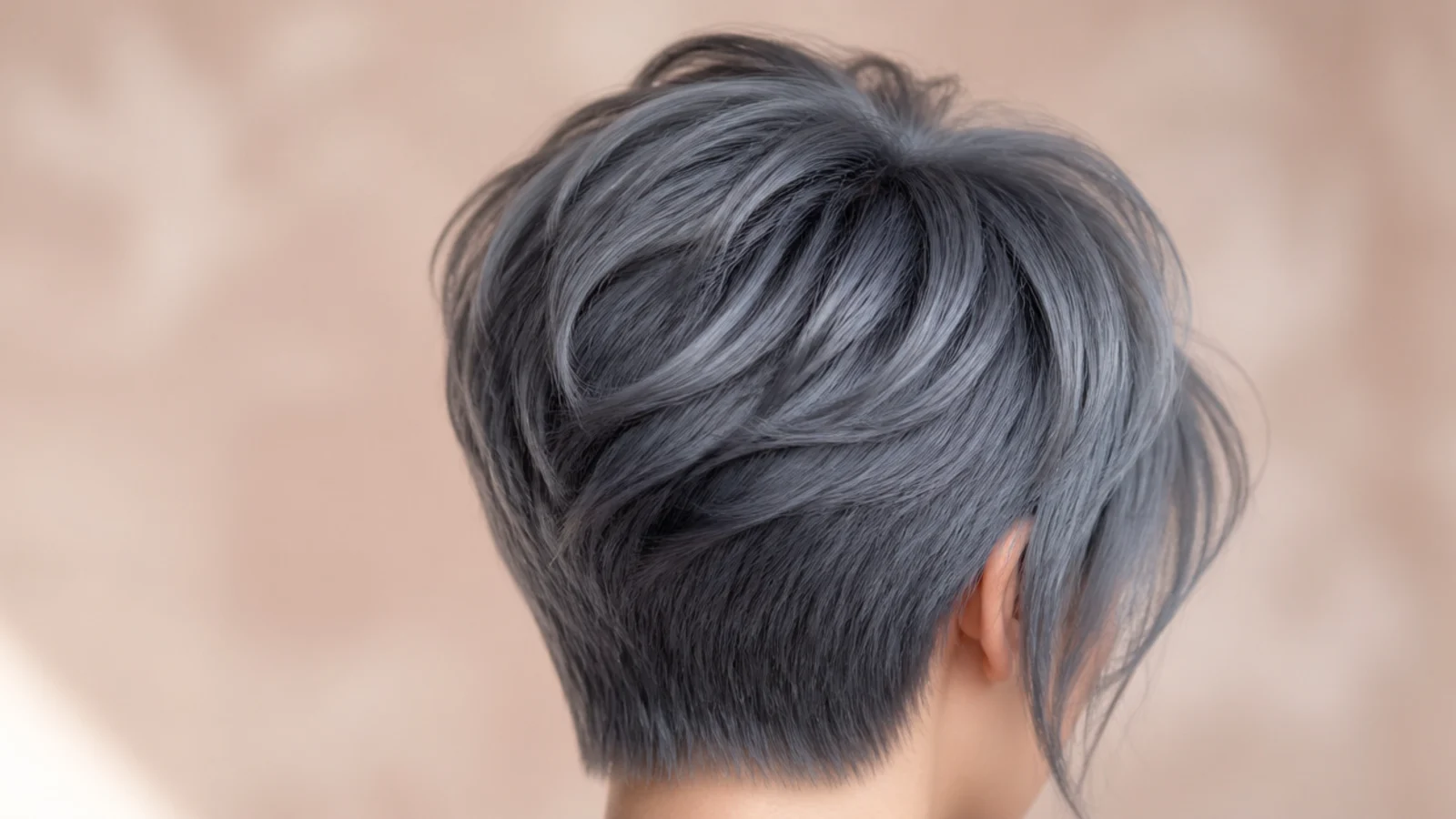 Smoky blue gray pixie cut with textured piecey layers at the crown, back view
