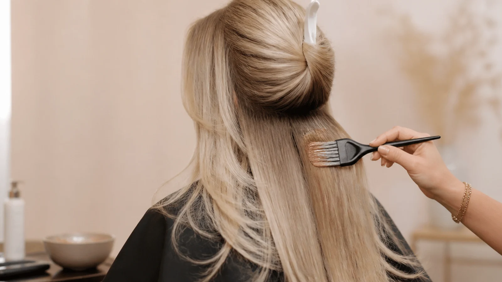 Bleached blonde hair mid-appointment with a warm filler applied through the porous ends