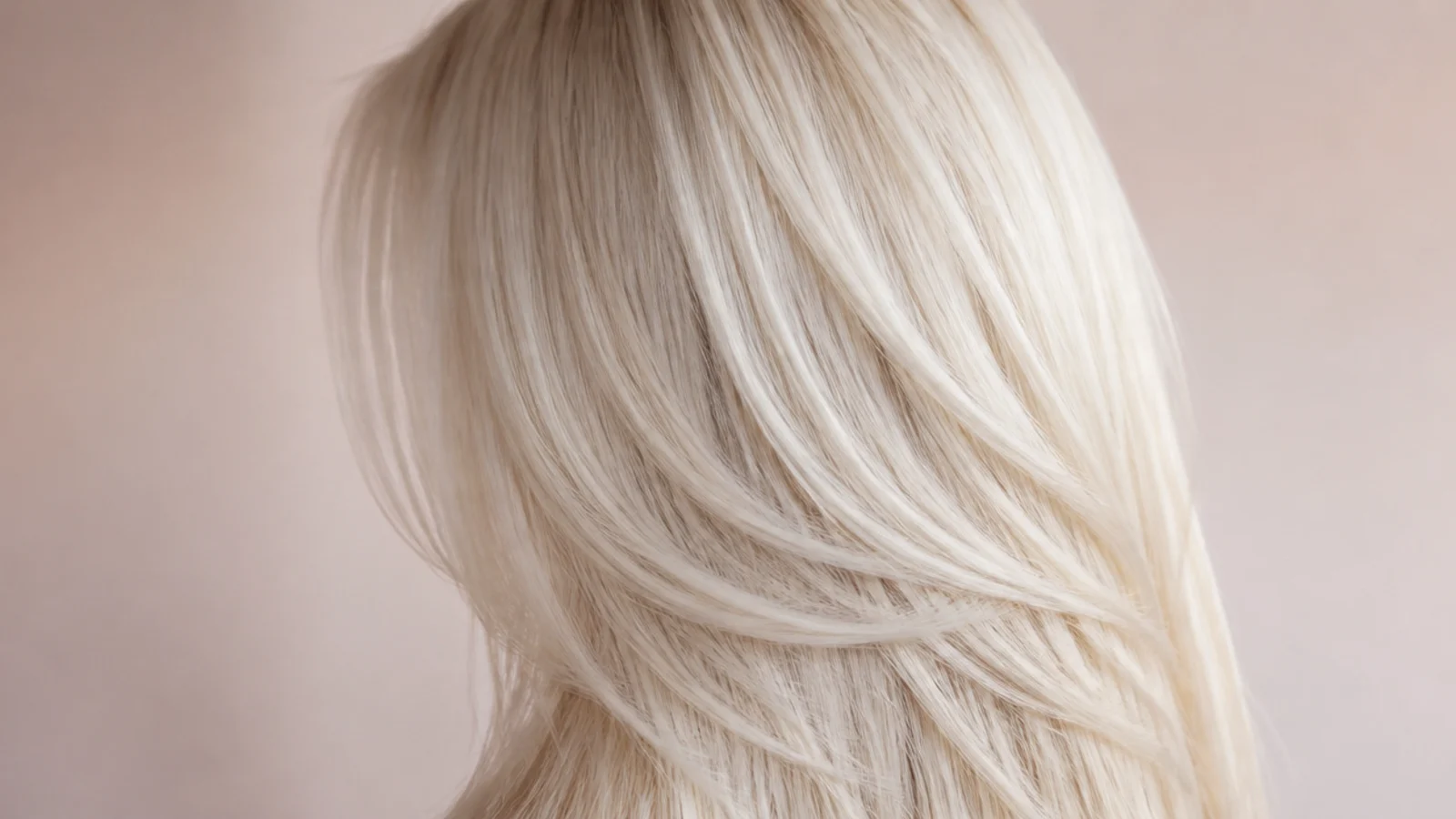 Icy platinum blonde hair color on long layers showing a bright cool blonde from behind