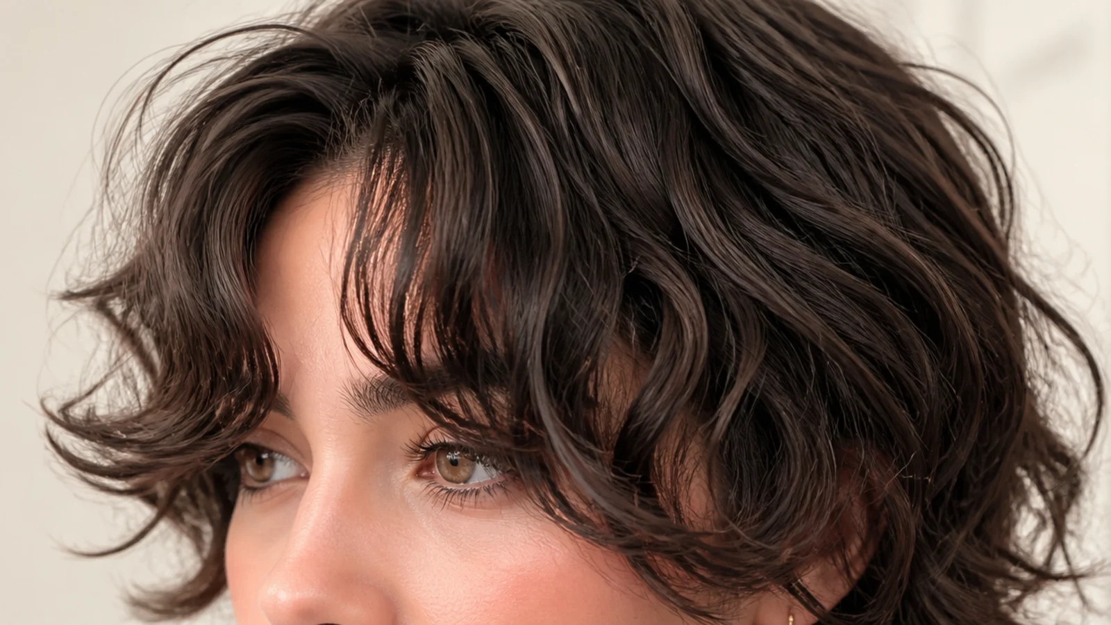 Curly short curtain bangs on 2c waves, brow-skimming in the center with cheekbone-length sides