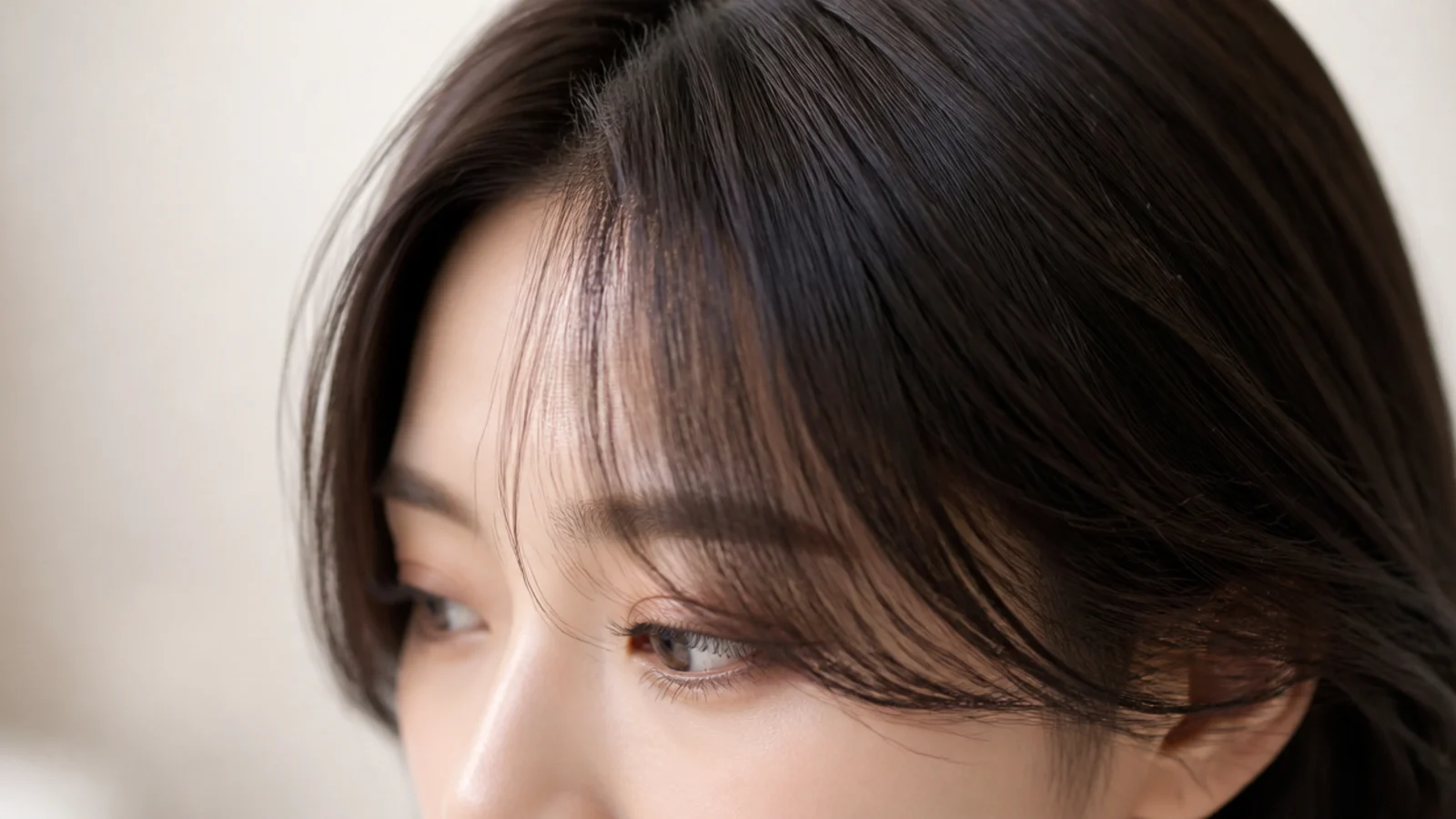 Korean short curtain bangs cut into thick dark hair with the weight removed underneath