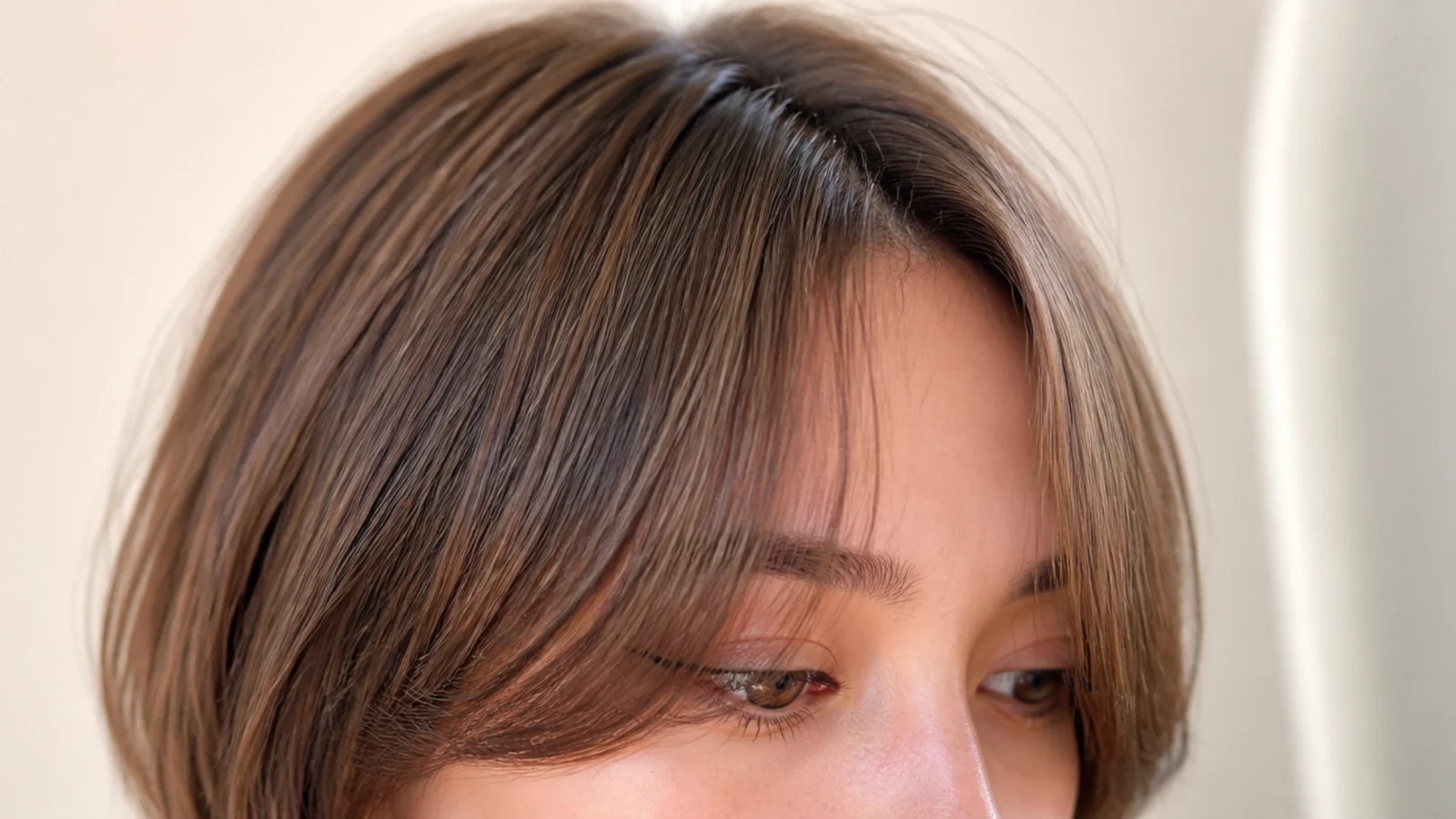 Layered bob with a U shaped short curtain fringe shorter in the center and longer at the temples