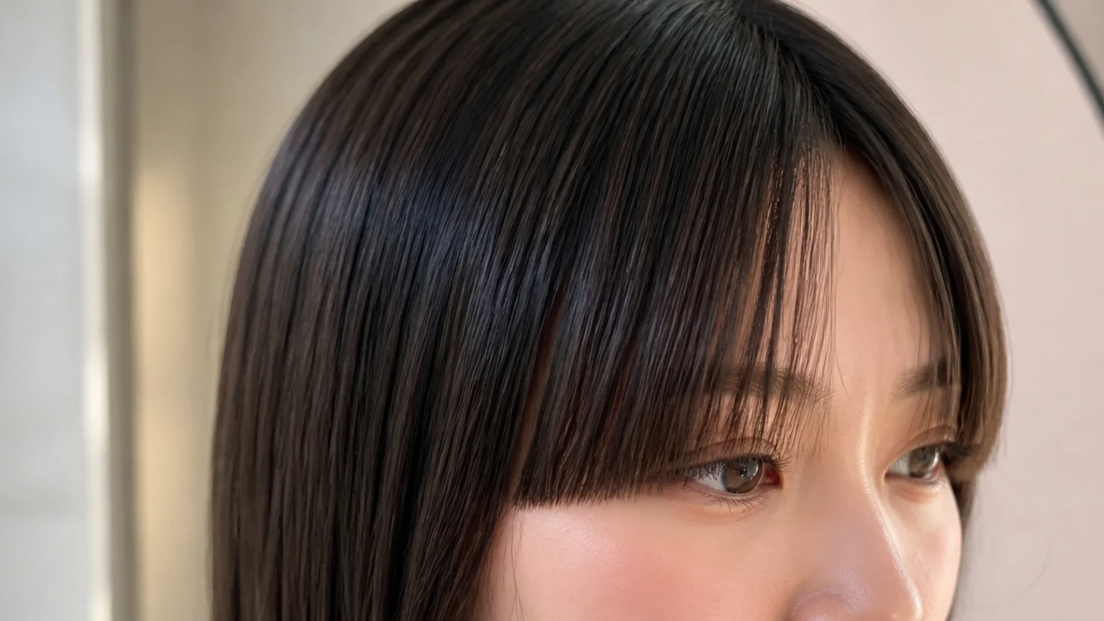 Blunt cut short curtain bangs with a hard perimeter line at eyebrow level on straight hair