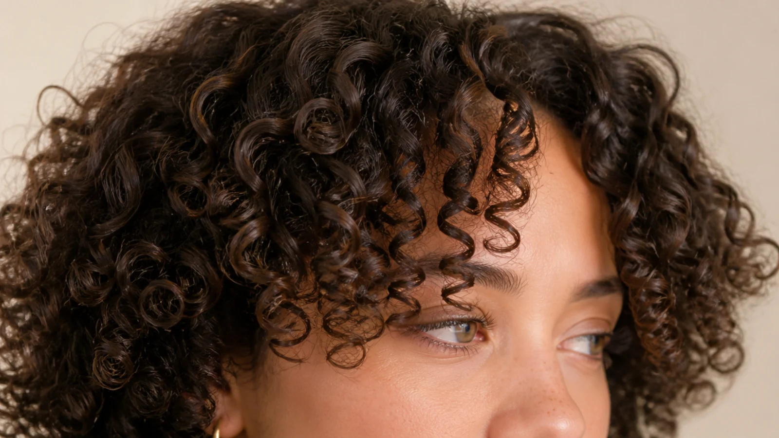 Curly short curtain bangs on 3b curls cut dry with defined spirals framing the face