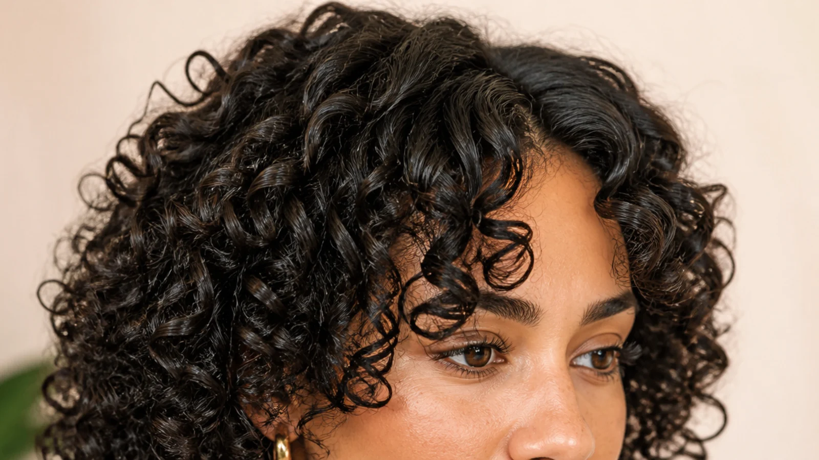 Soft short curtain bangs on 3a curly hair cut dry with defined curl clumps framing the face