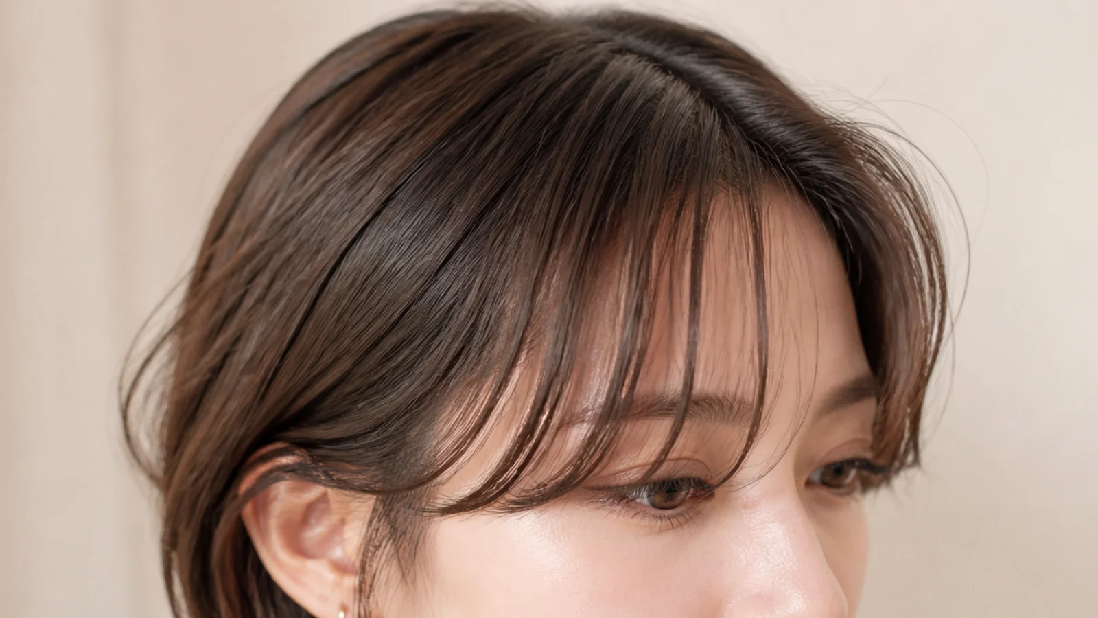 Wispy see-through wavy short curtain bangs on fine hair with visible separation and root lift