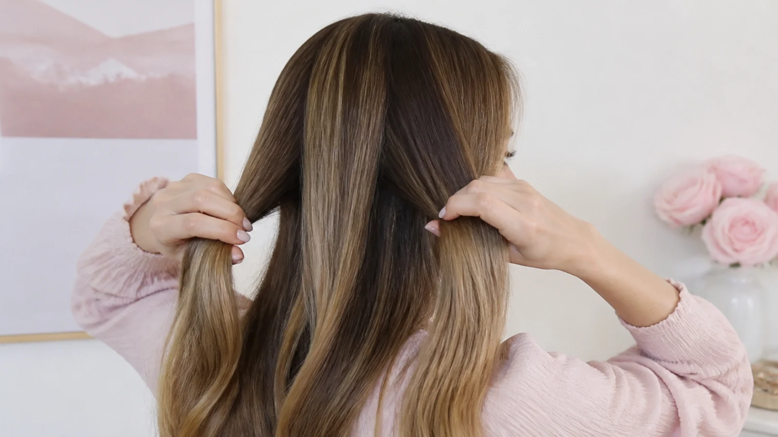 Hair divided into three equal sections held ready to begin a braid