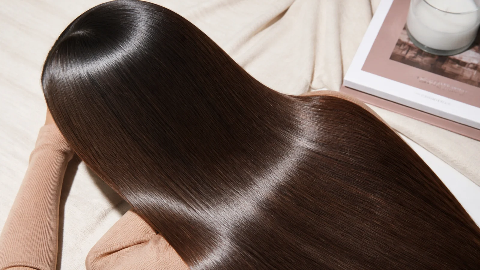 Faceless straight-down view of sleek glass hair with a flat mirror-like high-shine finish