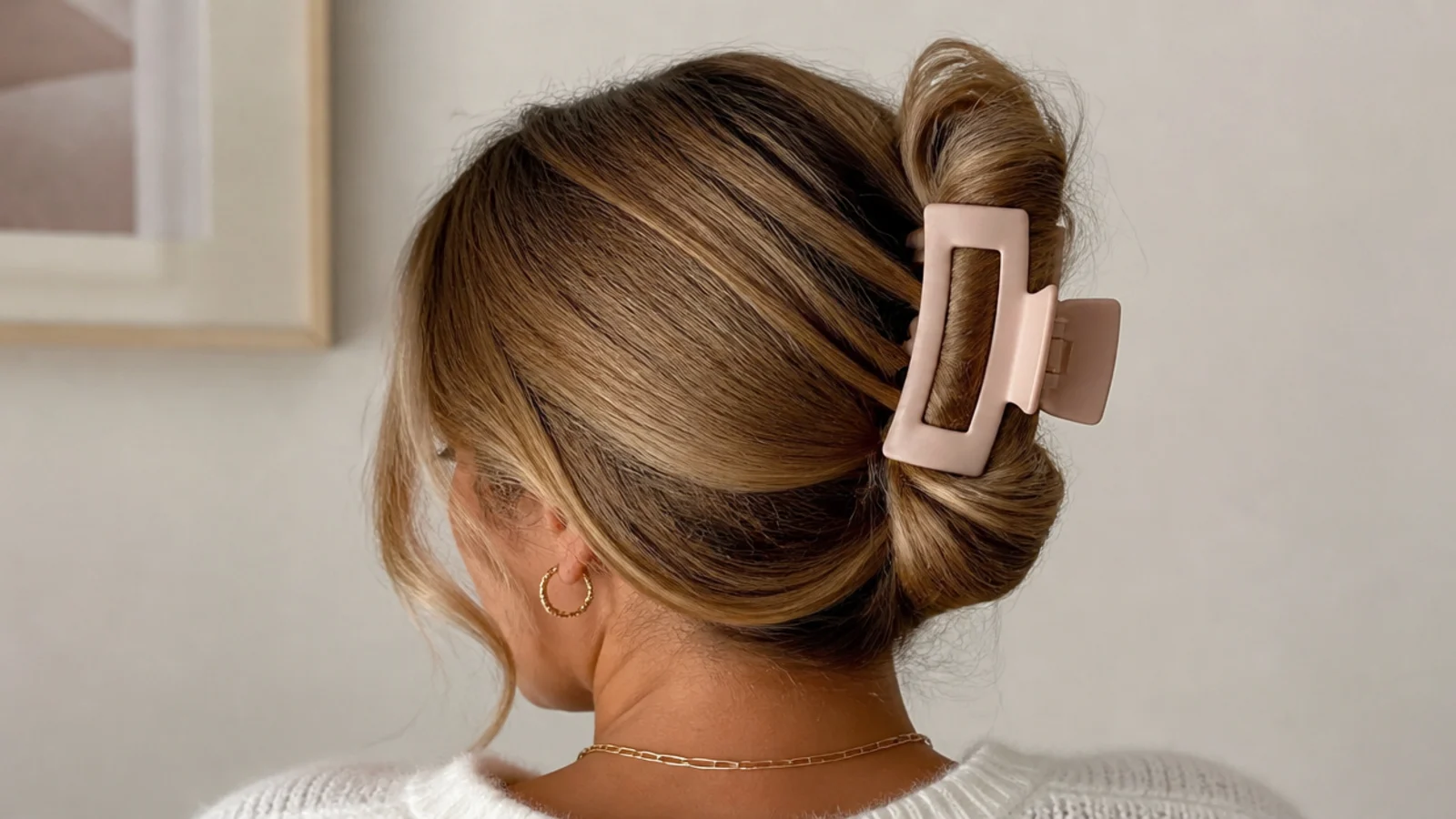 Faceless back view of a full claw-clip updo twisting medium hair up into a large clip