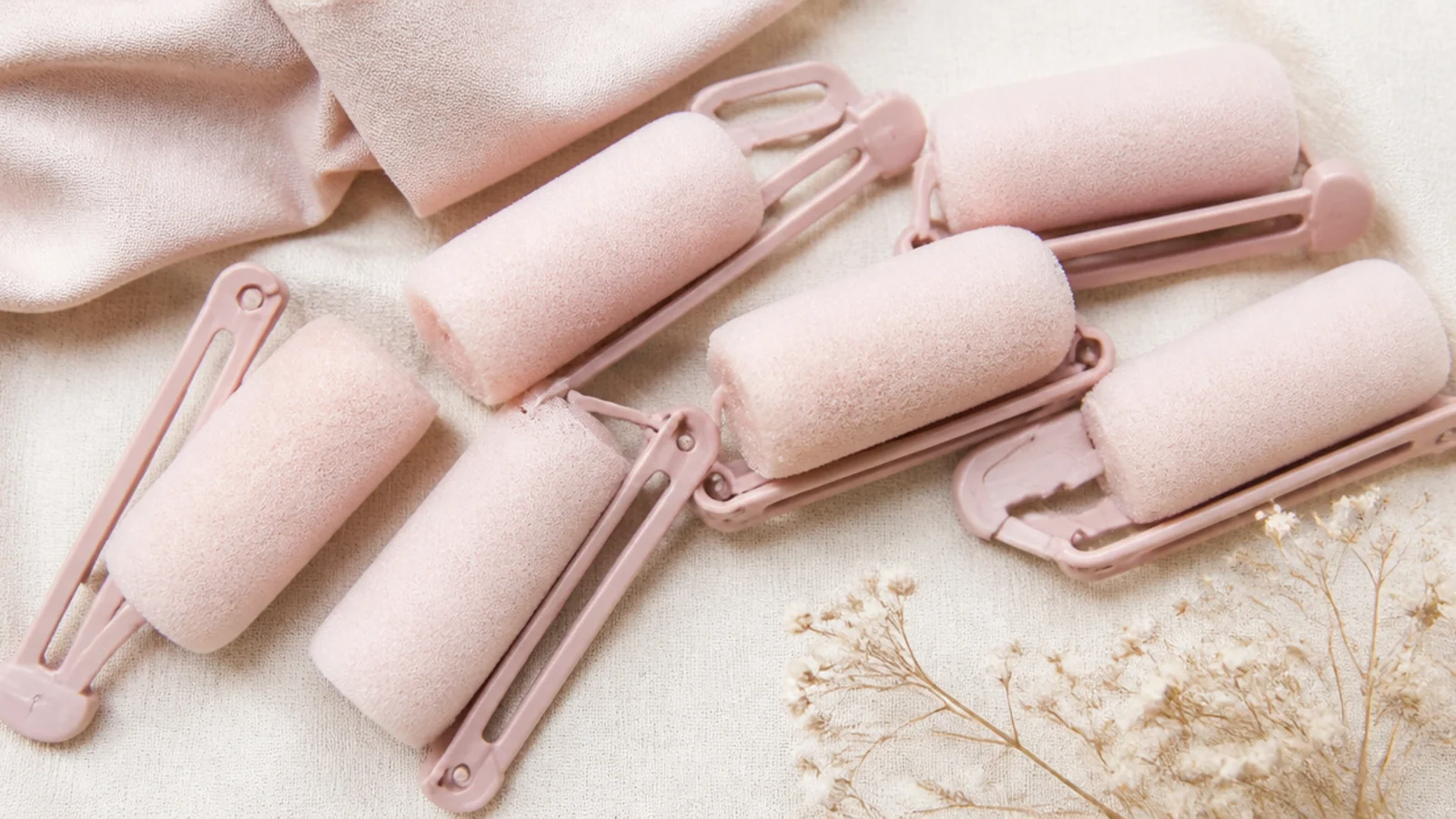 Faceless flat lay of soft foam sponge rollers with snap clips for heatless curls