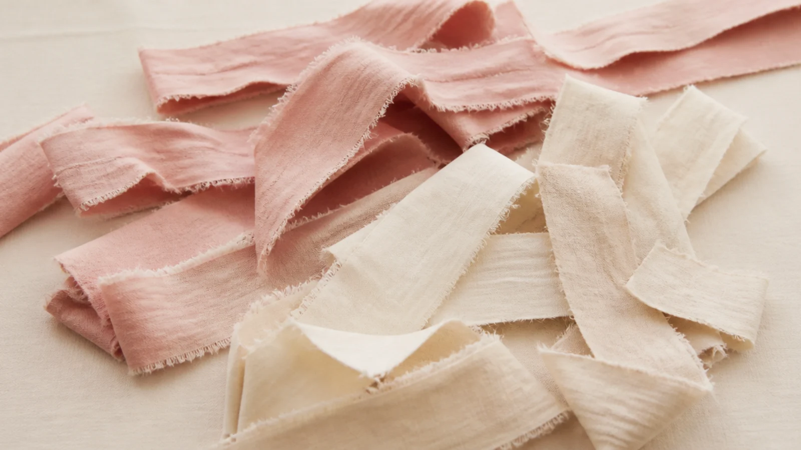 Faceless flat lay of torn cotton fabric strips used as rag rollers for heatless curls
