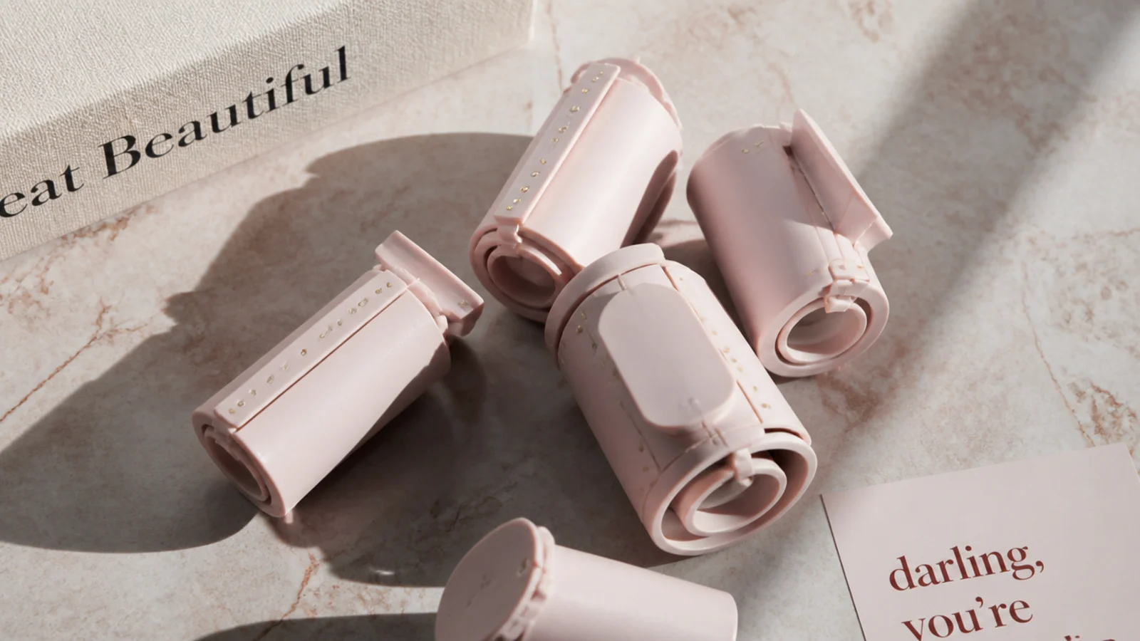 Faceless flat lay of smooth hard magnetic rollers used for a vintage heatless wet set
