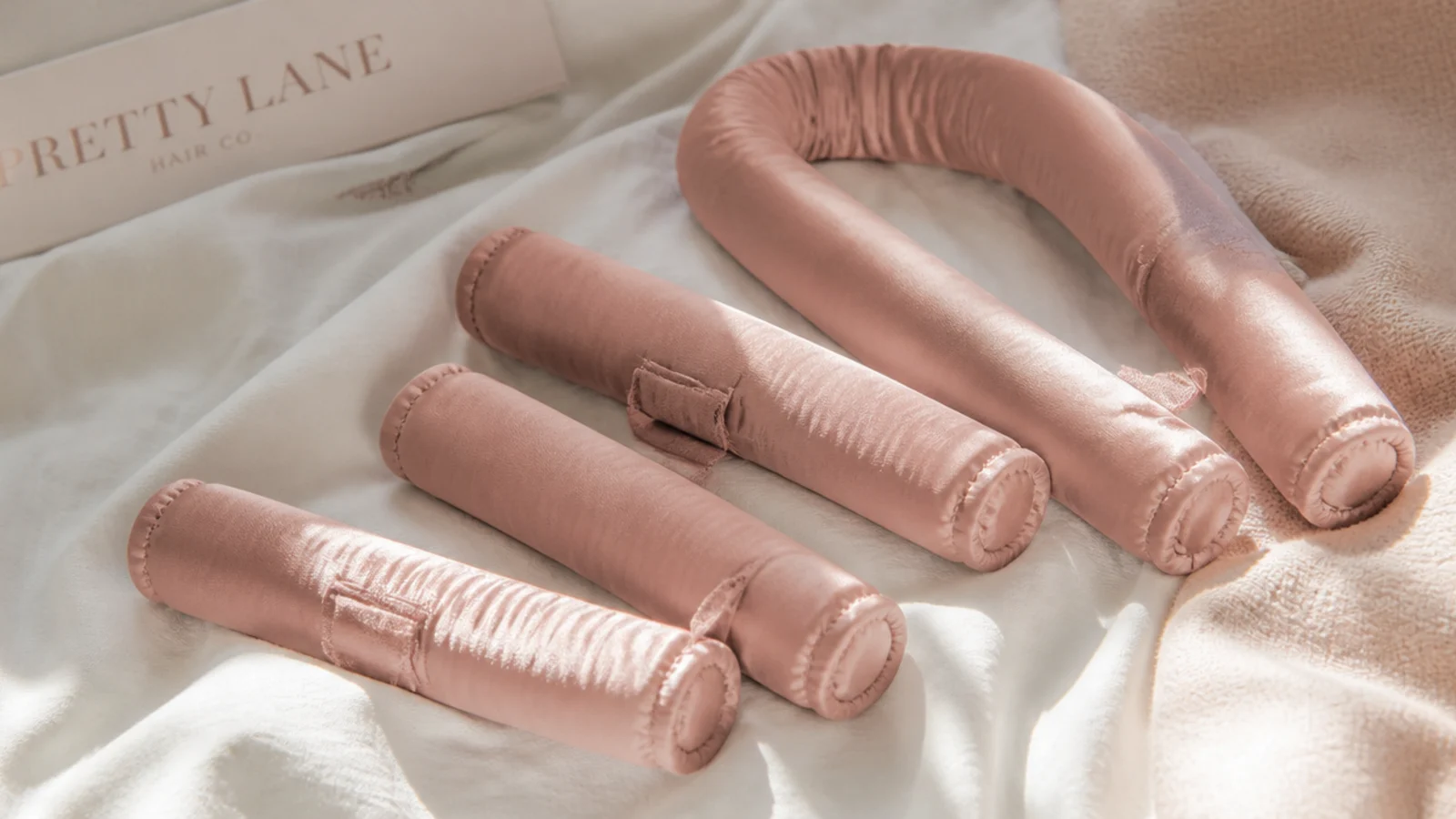Faceless flat lay of squishy pillow-soft padded fabric rollers for comfortable overnight curls