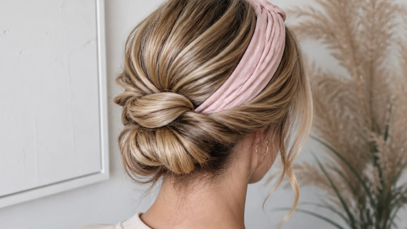Faceless back view of a Gibson tuck rolled updo on long hair over a headband