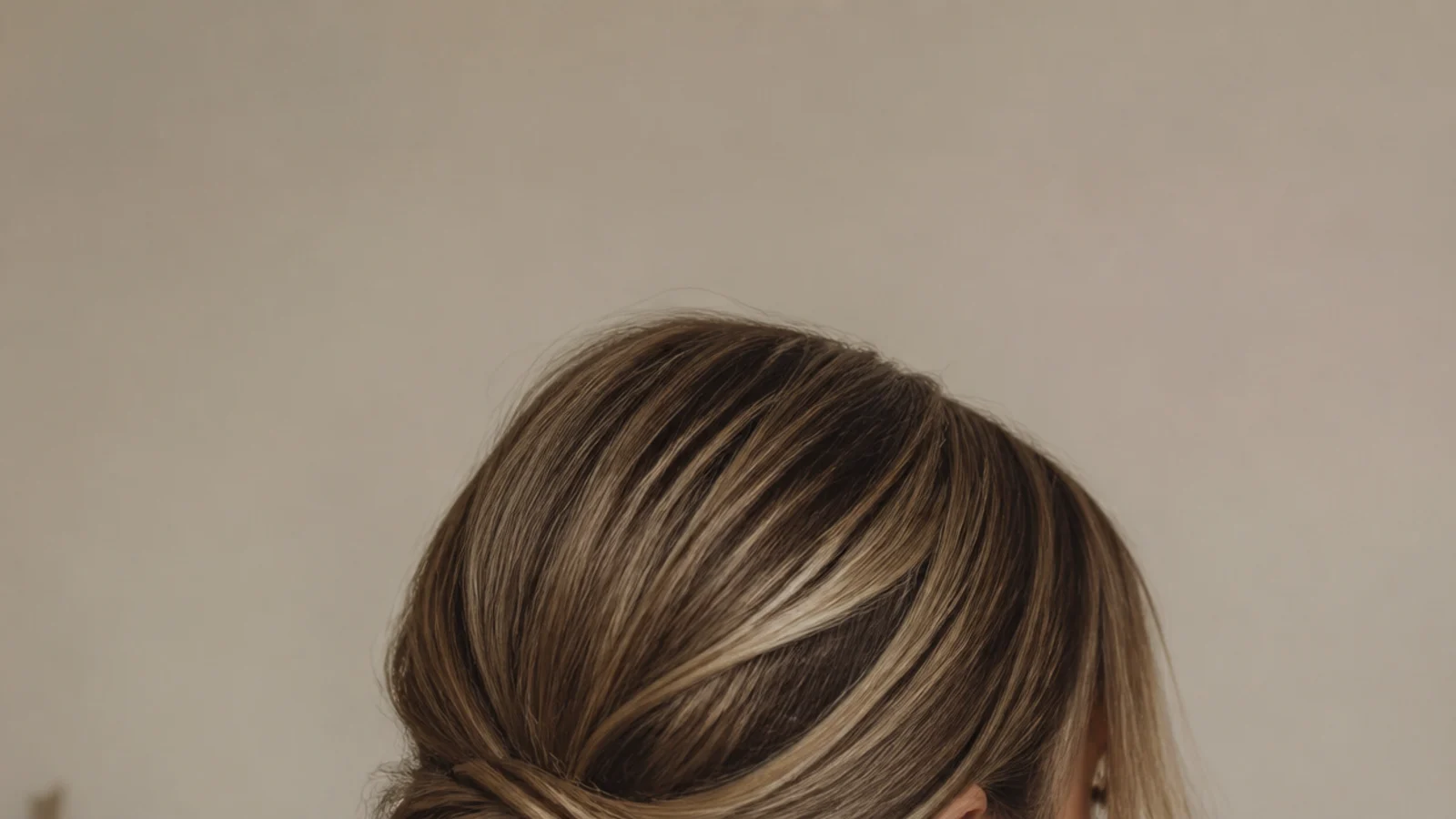 18 long hair updos that survive a full day, vertical Pinterest style back view of a twisted low bun