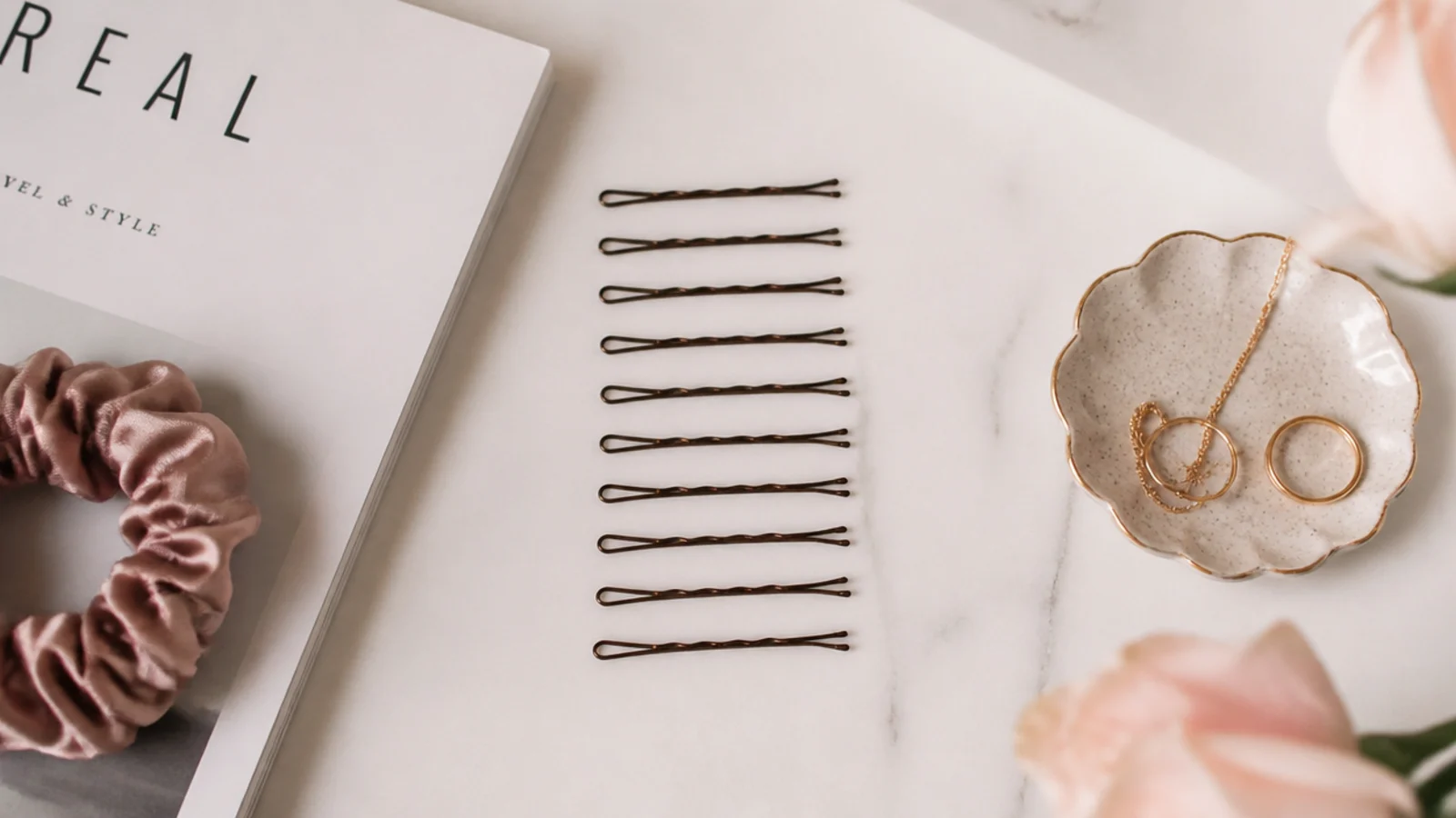 Faceless flat lay of a dozen bobby pins counted out for a long thick hair chignon
