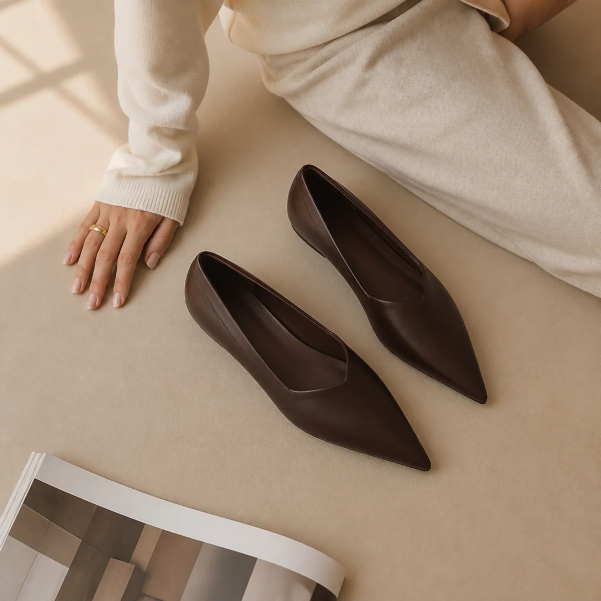 Faceless waist-down shot of slim sweatpants with sleek pointed flats
