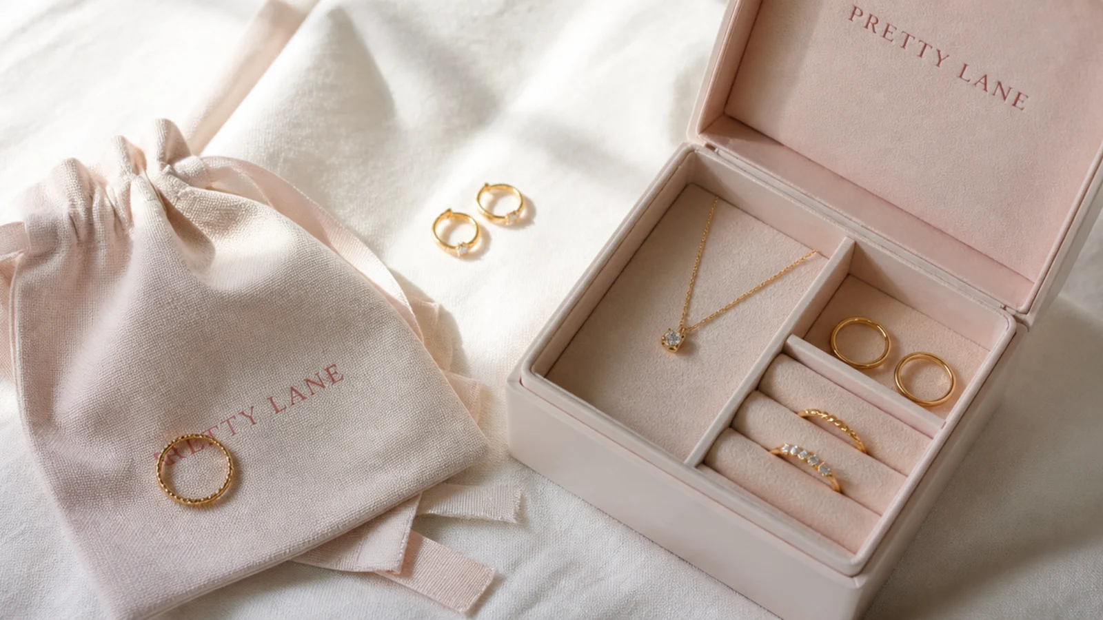 Faceless flat lay of a soft cloth, pouch and jewelry box used to store gold pieces dry