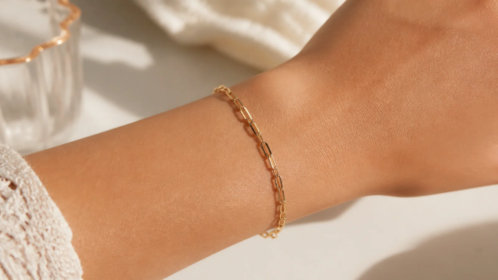 Faceless close-up of a gold vermeil chain bracelet on a wrist, an affordable demi-fine pick under fifty dollars
