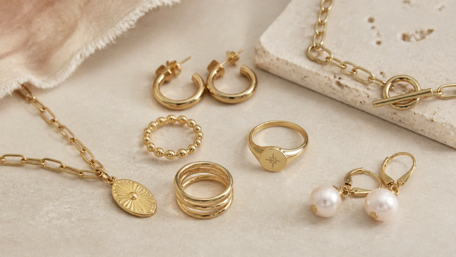 Faceless flat-lay matching gold-filled rings, vermeil earrings and plated trend pieces to their best uses