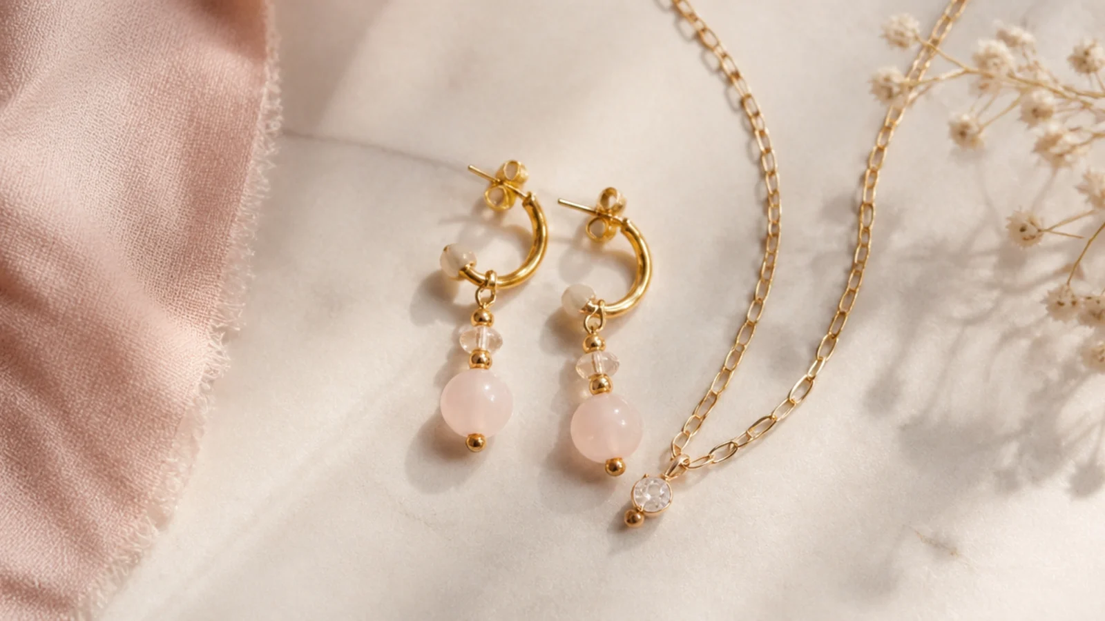 Faceless flatlay showing one hero earring pair chosen alongside a single supporting chain