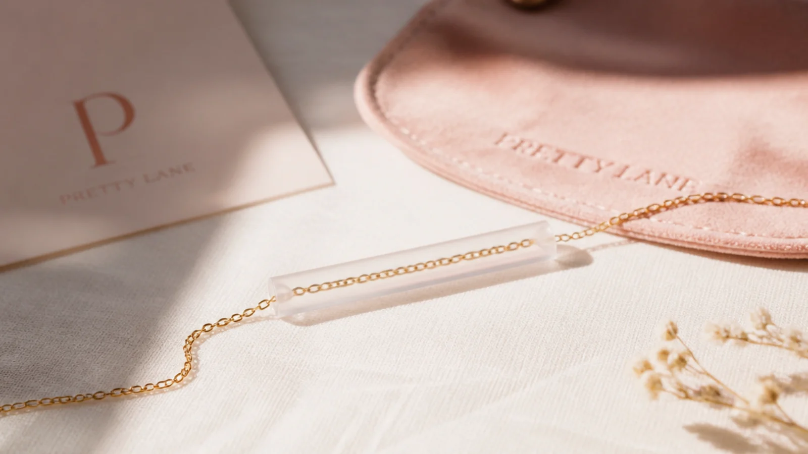 Faceless close-up of a delicate chain threaded through a cut drinking straw to prevent tangling