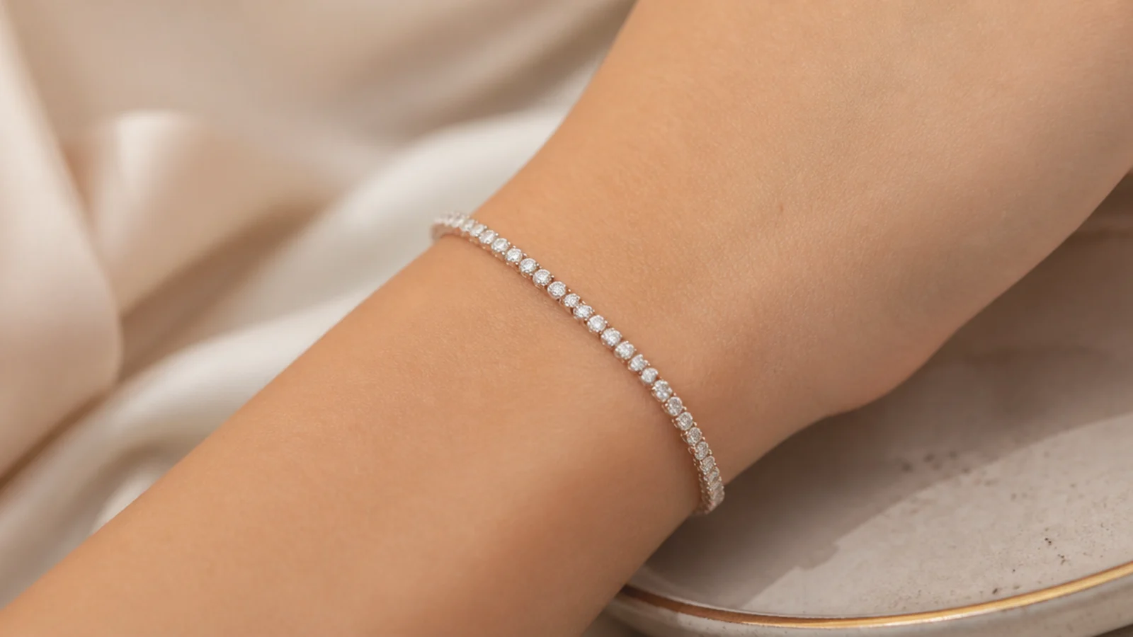 Faceless close-up of a slim lab-grown diamond tennis bracelet on a wrist