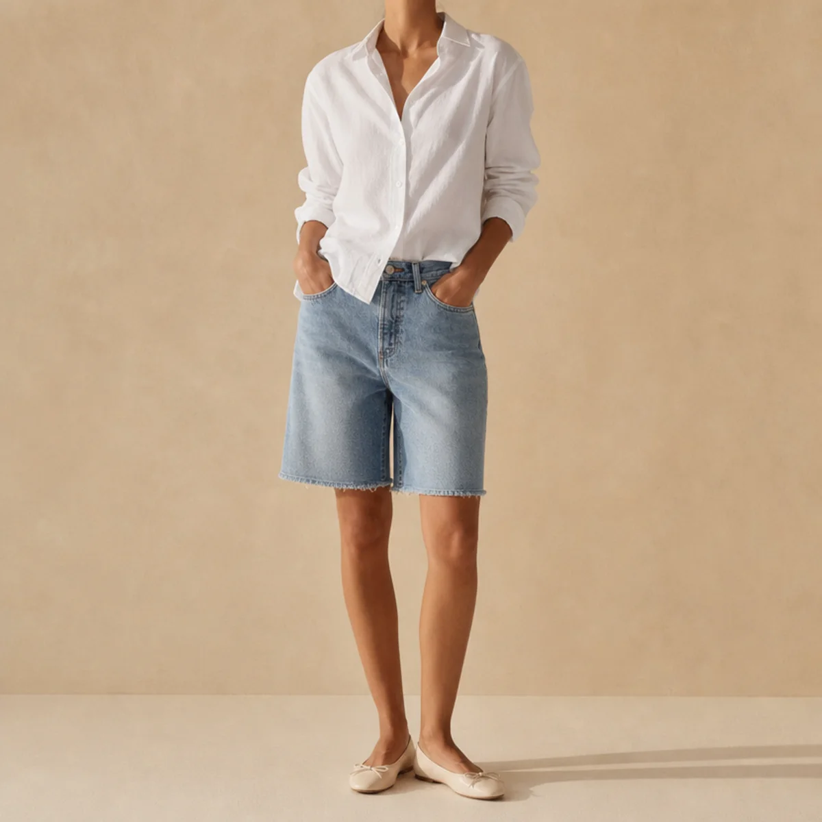 Faceless waist-up shot of a crisp white shirt half-tucked into jorts with ballet flats