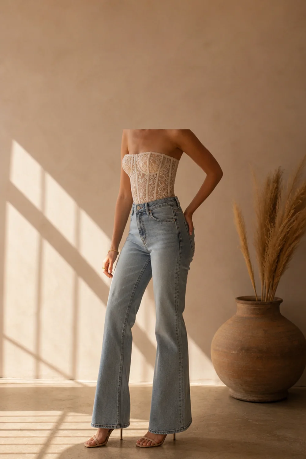 Faceless lace corset outfit with jeans and heels