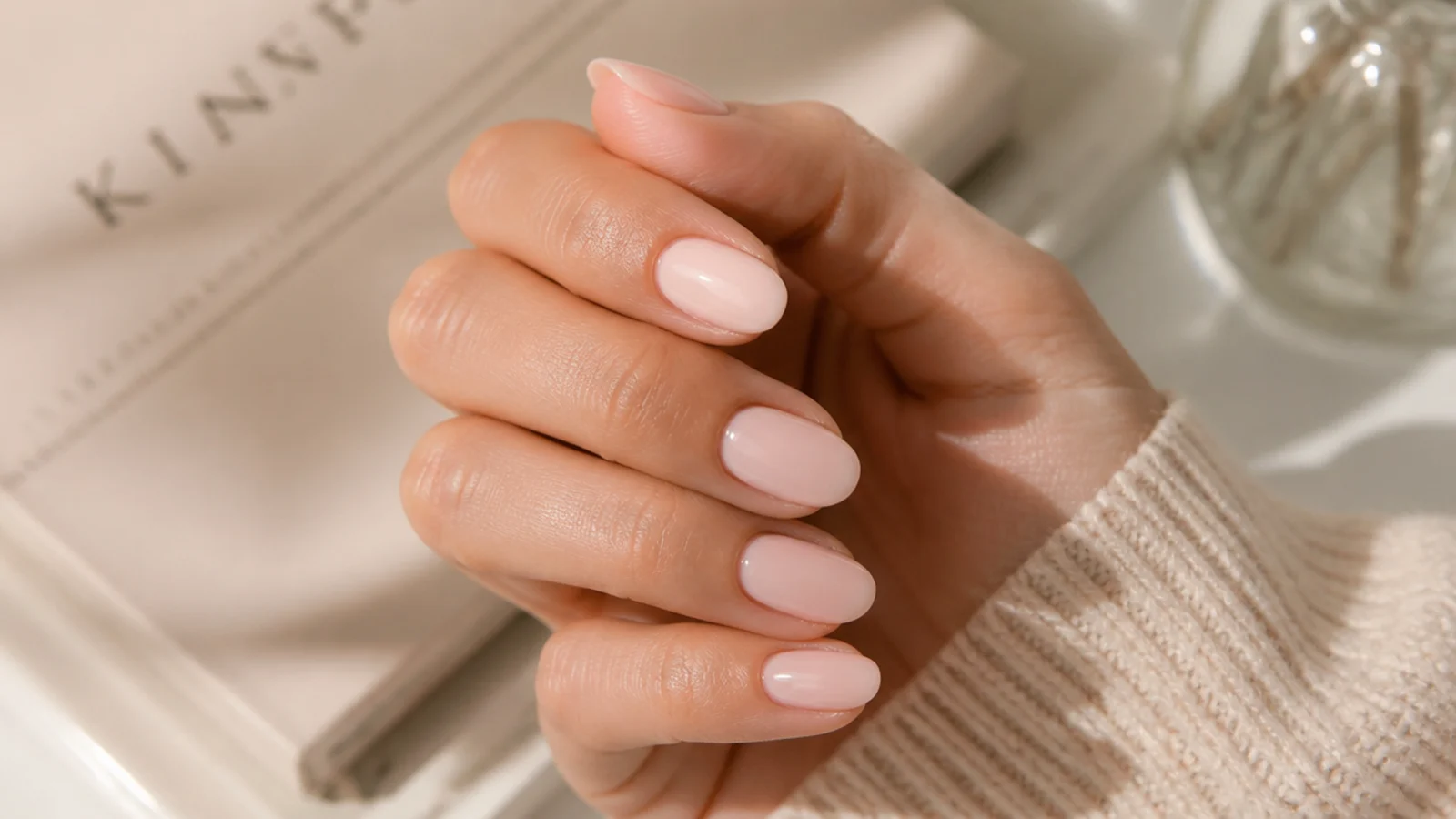 Short soft almond nails in milky nude showing the shallower 2026 taper and blunted tip
