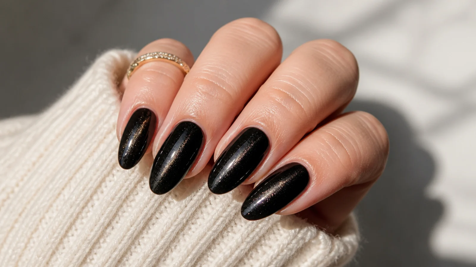 Black velvet cat eye almond nails with a soft magnetic light band running down each nail