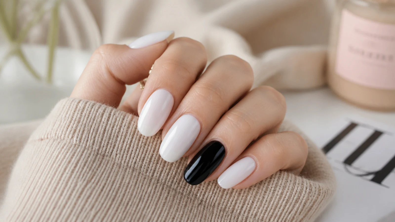 Milky white almond nails with one solid glossy black ring finger accent nail