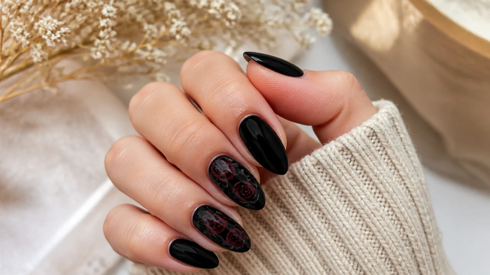 Black almond nails with hand-painted dark roses and thin gray outlines on two accent nails